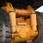 Detailed view of large off-road vehicle's suspension and wheels outdoors.